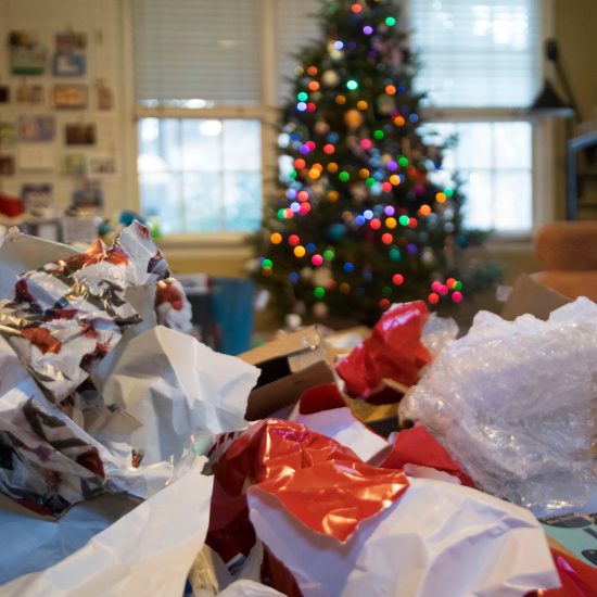 piles of wrapping paper in front of a Christmas tree